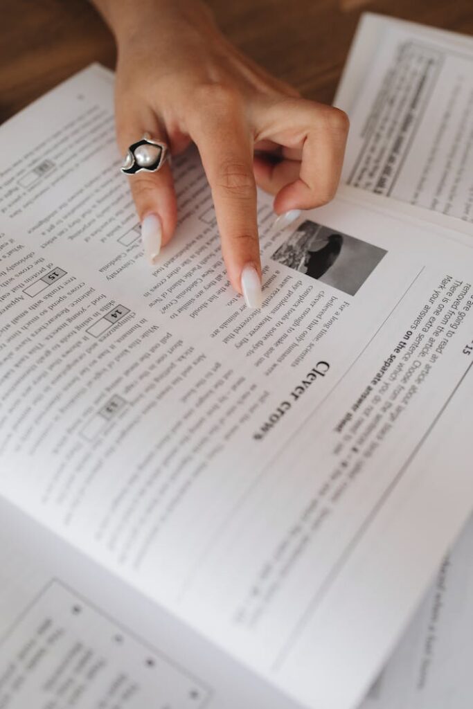 Close-Up View of a Person's Hand on a Book